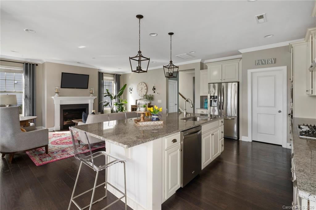 274 Helton Lane Fort Mill, SC 29708 - Photo 21 of 44 a kitchen with stainless steel appliances kitchen island granite countertop a stove a sink and a wooden floor