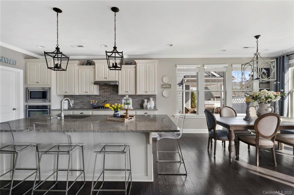274 Helton Lane Fort Mill, SC 29708 - Photo 23 of 44 a view of a kitchen with kitchen island stainless steel appliances microwave cabinets dining table and chairs