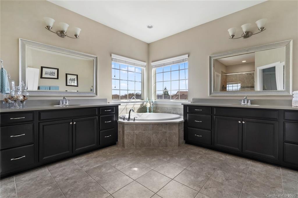 274 Helton Lane Fort Mill, SC 29708 - Photo 26 of 44 a spacious bathroom with a granite countertop double vanity sink a mirror and a bathtub