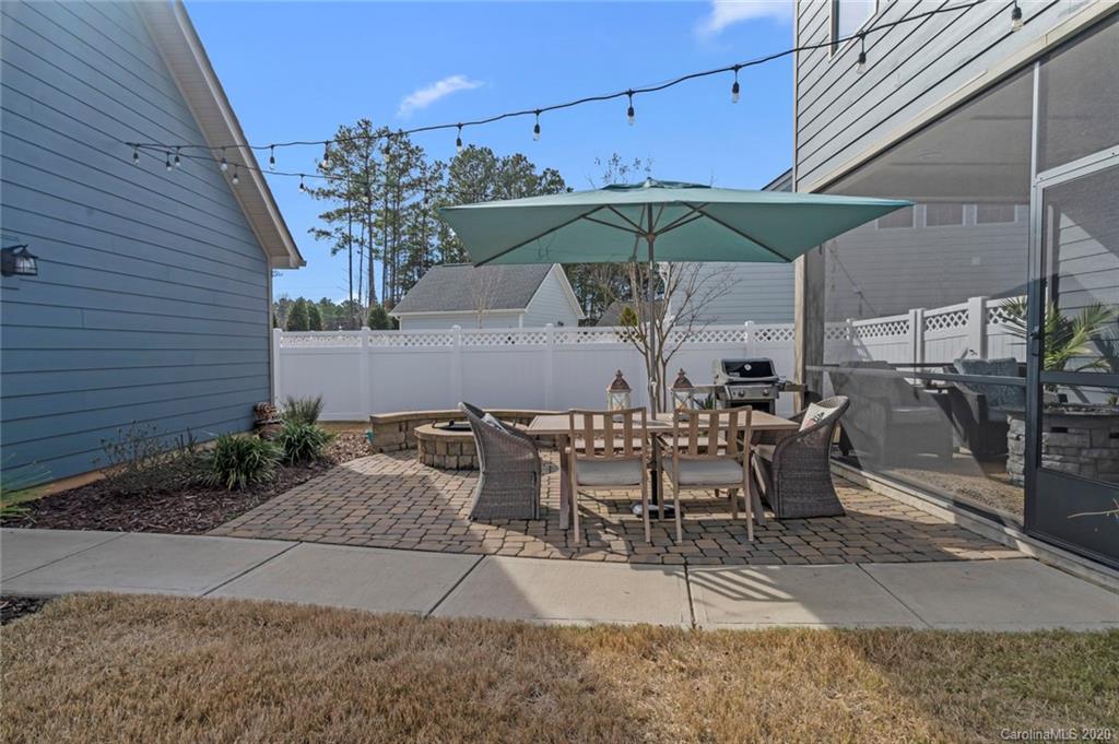 274 Helton Lane Fort Mill, SC 29708 - Photo 36 of 44 a view of a patio with table and chairs under an umbrella