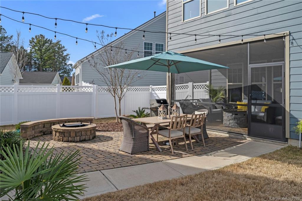 274 Helton Lane Fort Mill, SC 29708 - Photo 37 of 44 a view of a patio with table and chairs under an umbrella