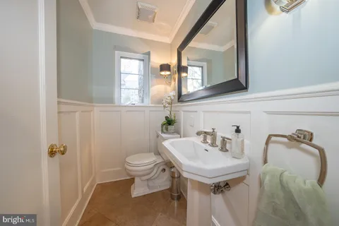 a bathroom with a sink toilet and mirror