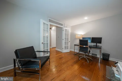 a view of a workspace with furniture and a window