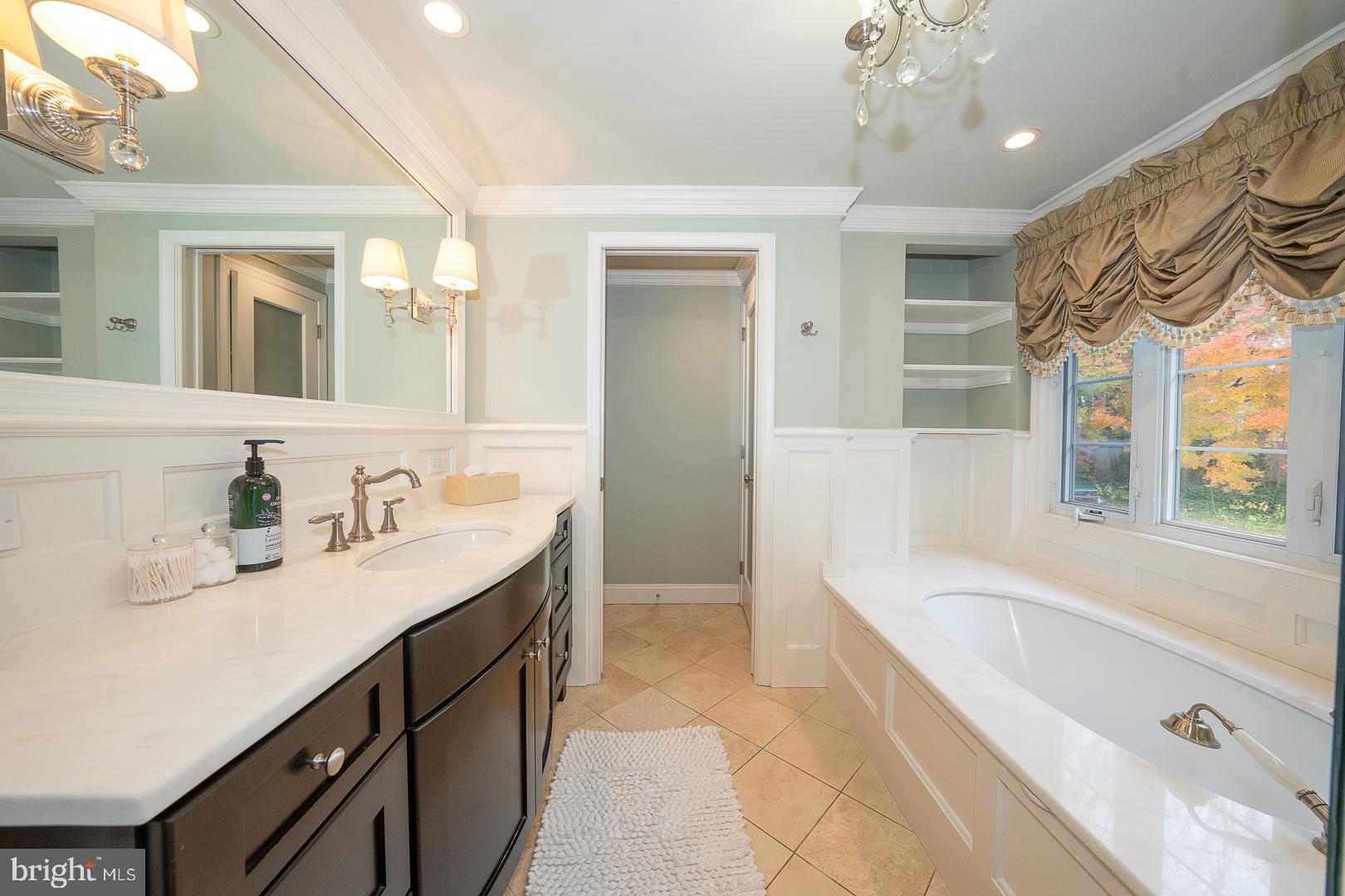 346 Winding Way Merion Station, PA 19066 - Photo 31 of 51 a spacious bathroom with a granite countertop sink a bathtub and a mirror