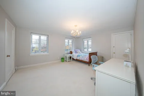 a bedroom with furniture and a chandelier