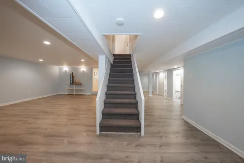 a living room with a couch and a wooden floor