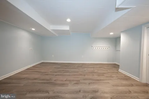 a view of a big room with wooden floor and staircase