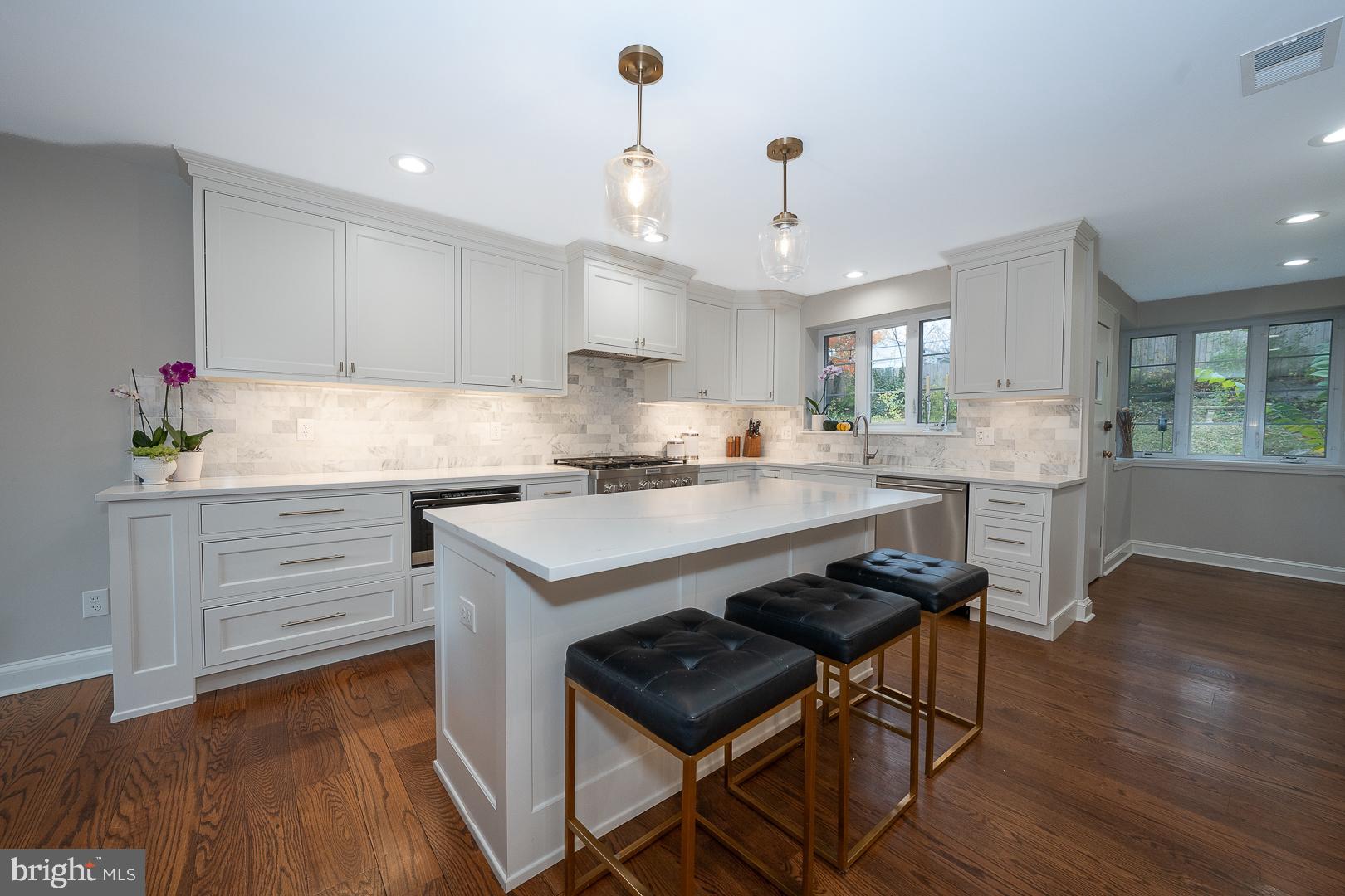 346 Winding Way Merion Station, PA 19066 - Photo 5 of 51 a kitchen with a table chairs refrigerator and cabinets