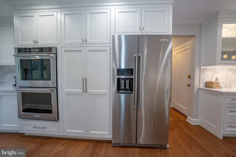 a view of a kitchen with refrigerator and microwave