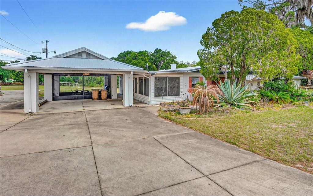 34618 South Haines Creek Road Leesburg, FL 34788 - Photo 2 of 41 a view of a house with backyard and a garden