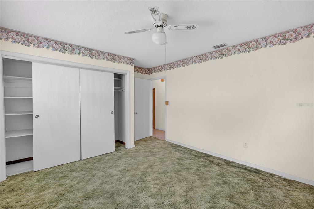 34618 South Haines Creek Road Leesburg, FL 34788 - Photo 30 of 41 a view of a big room with closet and a ceiling fan