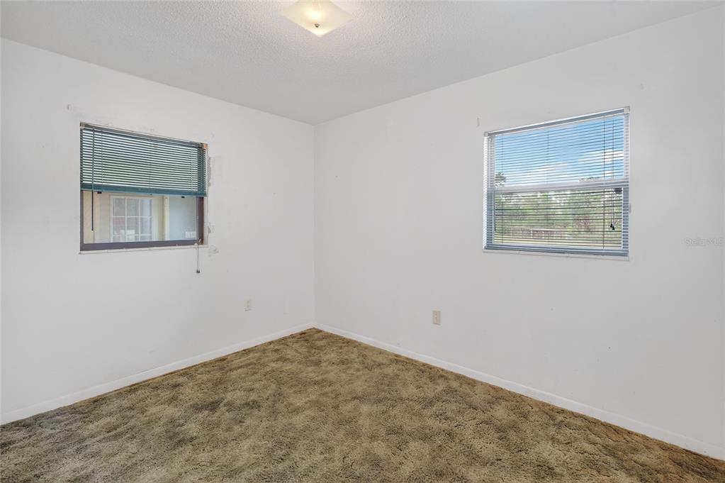 34618 South Haines Creek Road Leesburg, FL 34788 - Photo 32 of 41 a view of a big room with wooden floor and a window