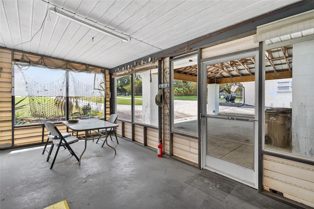34618 South Haines Creek Road Leesburg, FL 34788 - Photo 34 of 41 a dining room with furniture and a floor to ceiling window
