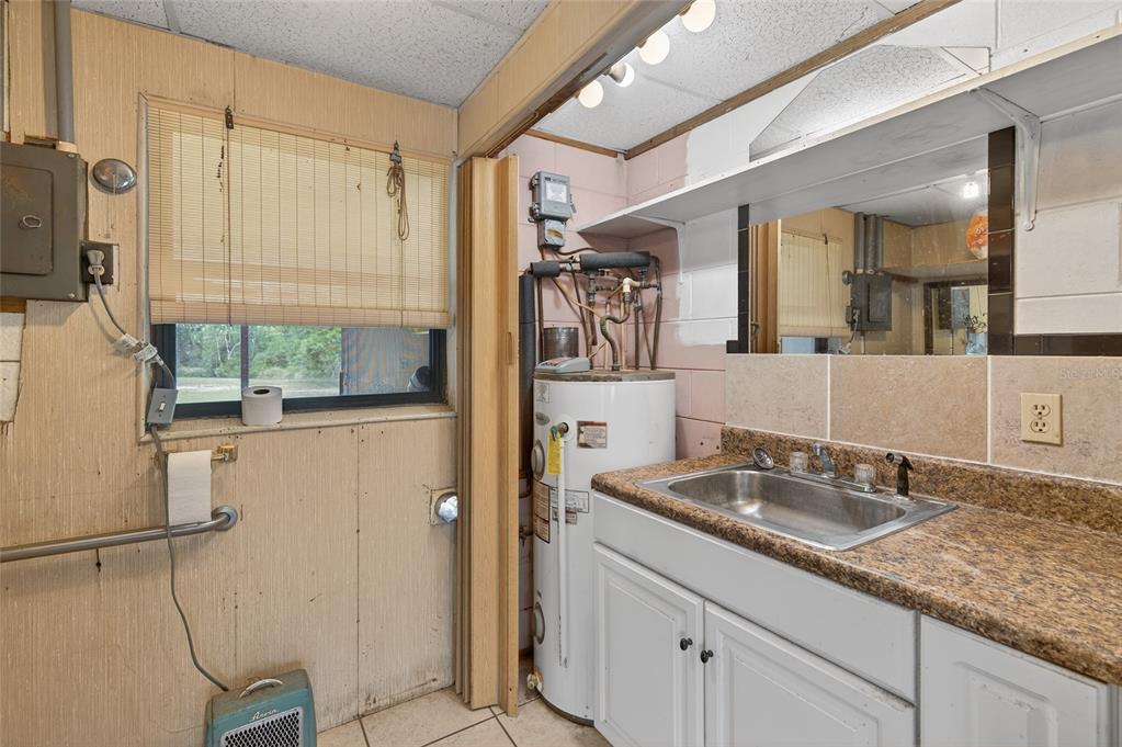 34618 South Haines Creek Road Leesburg, FL 34788 - Photo 36 of 41 a bathroom with a granite countertop sink a mirror and shower