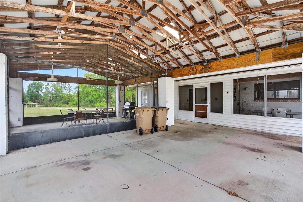34618 South Haines Creek Road Leesburg, FL 34788 - Photo 38 of 41 a view of a patio with a table and chairs next to a yard