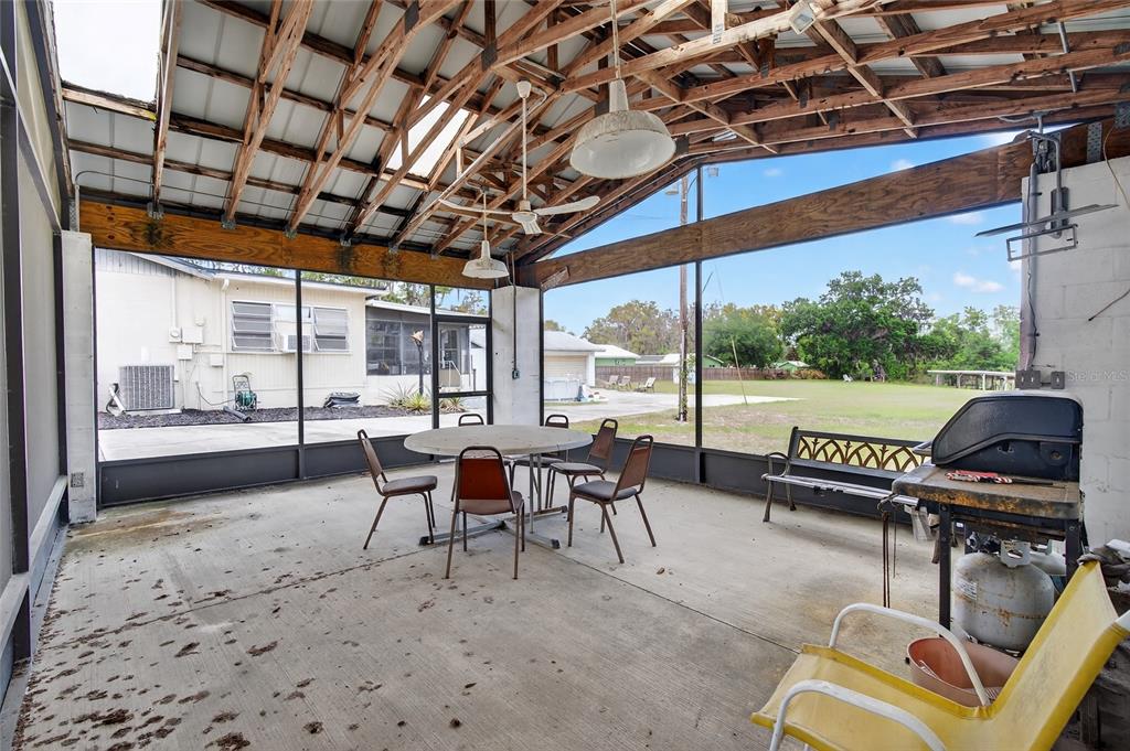 34618 South Haines Creek Road Leesburg, FL 34788 - Photo 39 of 41 a living room with furniture and a floor to ceiling window