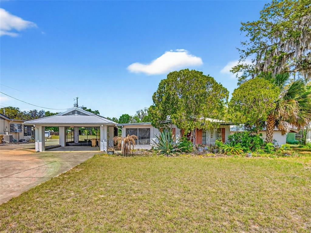 34618 South Haines Creek Road Leesburg, FL 34788 - Photo 5 of 41 a front view of a building with a yard
