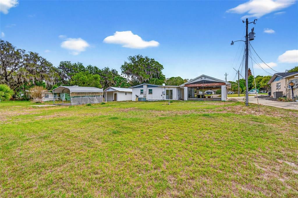 34618 South Haines Creek Road Leesburg, FL 34788 - Photo 9 of 41 a view of a swimming pool with an outdoor space and seating area