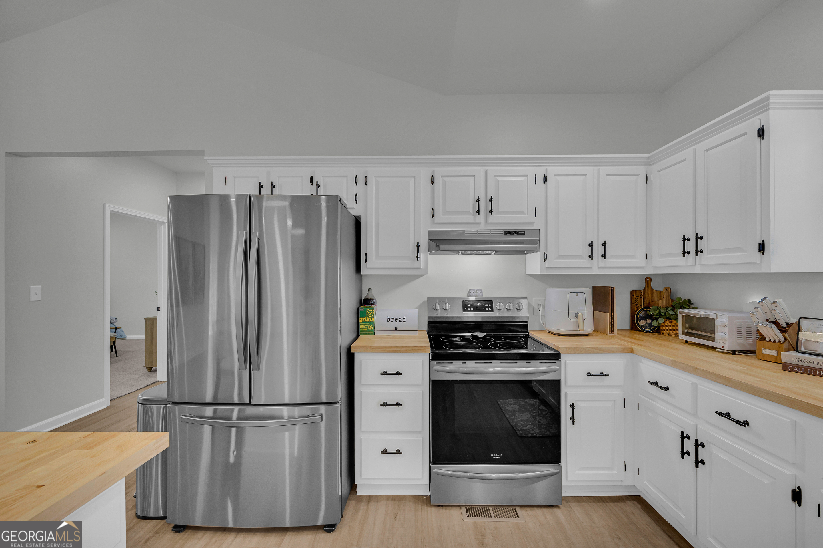 163 Tuxedo Drive Commerce, GA 30530 - Photo 26 of 62 a kitchen with cabinets and stainless steel appliances