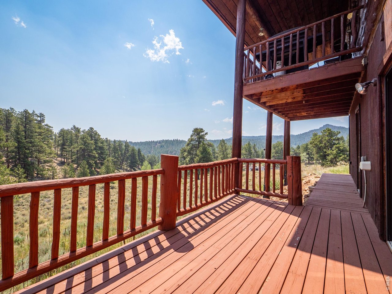 296 Caddo Road Red Feather Lakes, CO 80545 - Photo 46 of 50 Two levels of decks on the SW side of the cabin.