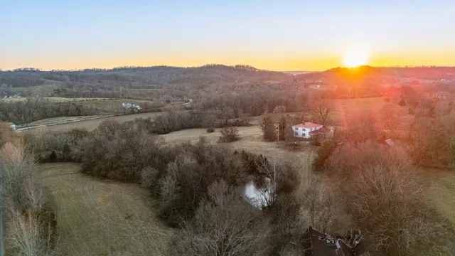 a view of a mountain in the distance in a field