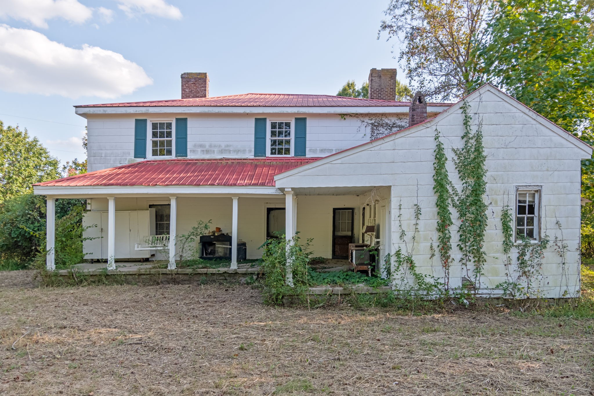 3213 Craig Bridge Road Williamsport, TN 38487 - Photo 25 of 47 a view of a white house with large windows and a table and chairs in a yard