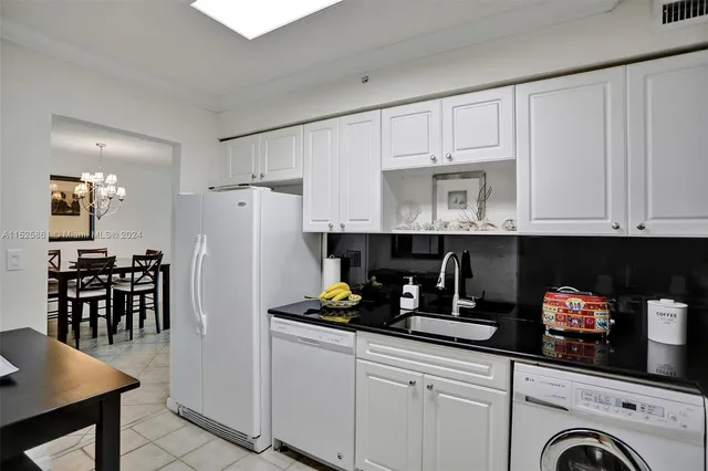 a kitchen with refrigerator and cabinets