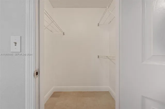 a bathroom with a granite countertop sink a toilet a mirror and shower