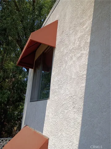 a view of a street with a large trees
