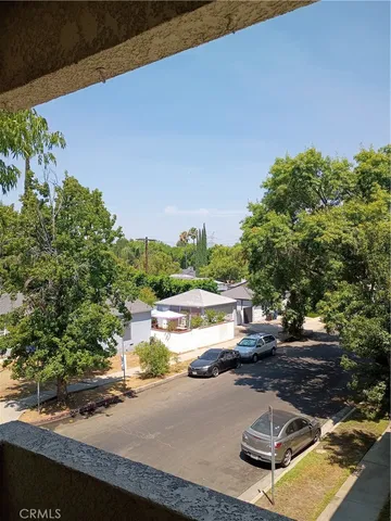 an empty room with wooden floor and windows in it