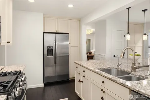 a kitchen with sink a stove and cabinets