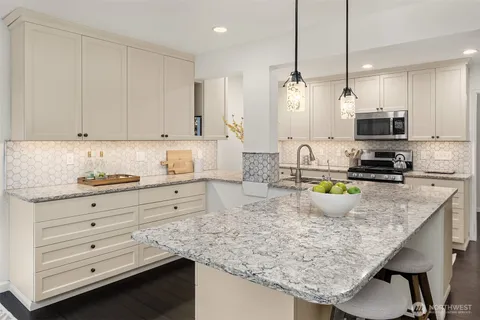 a bathroom with a granite countertop sink mirror and double