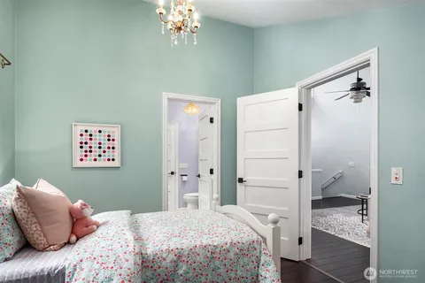 a bedroom with a bed lamp and a window