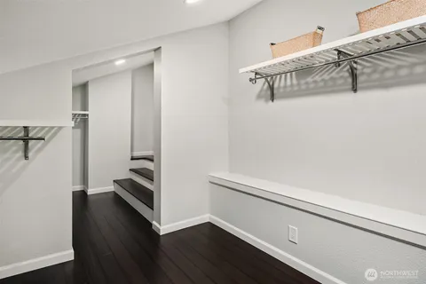 a bathroom with a sink a toilet a mirror and shower