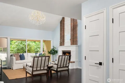 a living room with furniture a fireplace and a chandelier