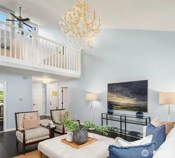 a living room with furniture a flat screen tv and a large window