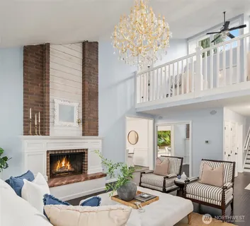 a living room with furniture a large window and a flat screen tv