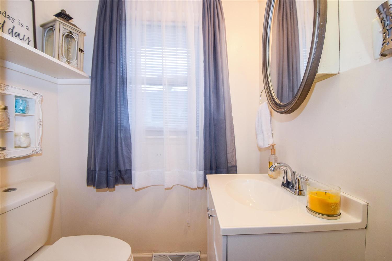 1914 Burma Road Salem, VA 24153 - Photo 12 of 20 a bathroom with a sink a toilet and a mirror