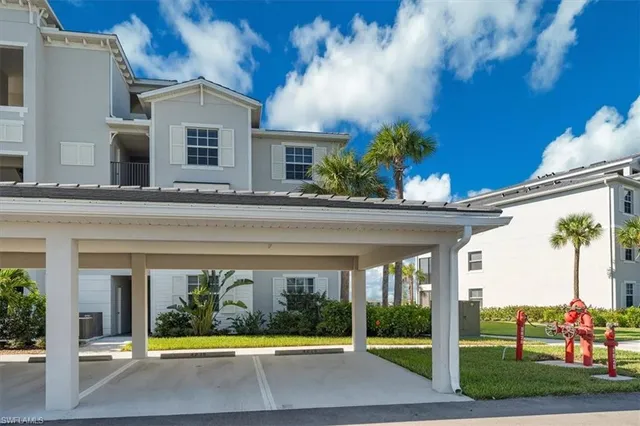 a view of a hallway with wooden floor and a living room