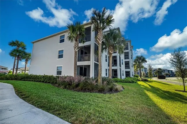 a kitchen with stainless steel appliances a table chairs refrigerator and cabinets