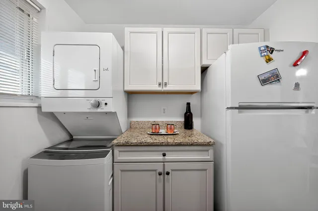 a white refrigerator freezer sitting inside of a kitchen