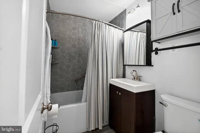 a bathroom with a sink a mirror and a shower