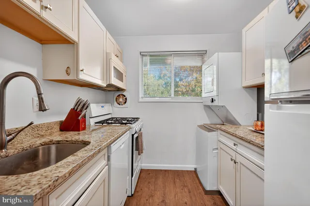 a kitchen with stainless steel appliances granite countertop a stove and a sink