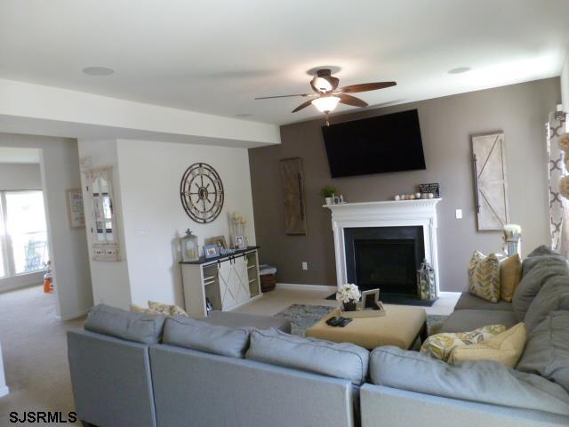 218 Surf Road Egg Harbor Township, NJ 08234 - Photo 11 of 28 a living room with furniture a fireplace and a flat screen tv