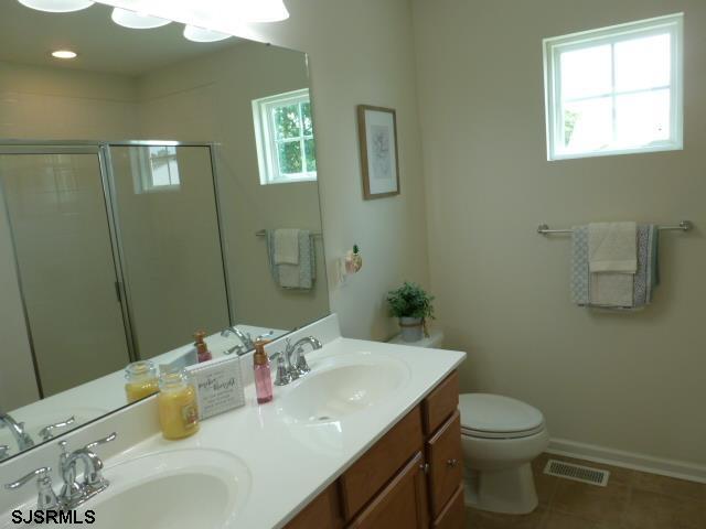 218 Surf Road Egg Harbor Township, NJ 08234 - Photo 14 of 28 a bathroom with a sink vanity mirror and toilet