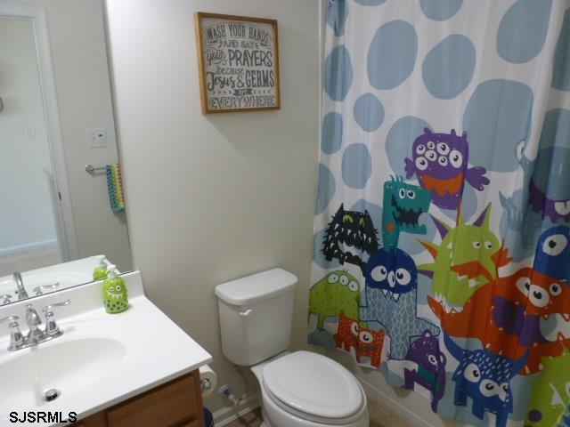 218 Surf Road Egg Harbor Township, NJ 08234 - Photo 16 of 28 a white toilet sitting next to a bathroom sink