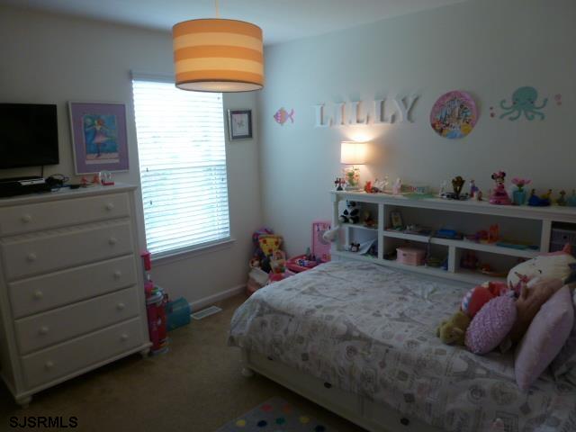 218 Surf Road Egg Harbor Township, NJ 08234 - Photo 20 of 28 a bedroom with a bed and a window