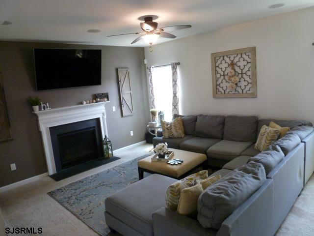 218 Surf Road Egg Harbor Township, NJ 08234 - Photo 4 of 28 a living room with furniture a flat screen tv and a fireplace