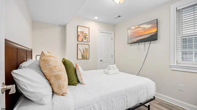 a bedroom with a bed and a flat screen tv
