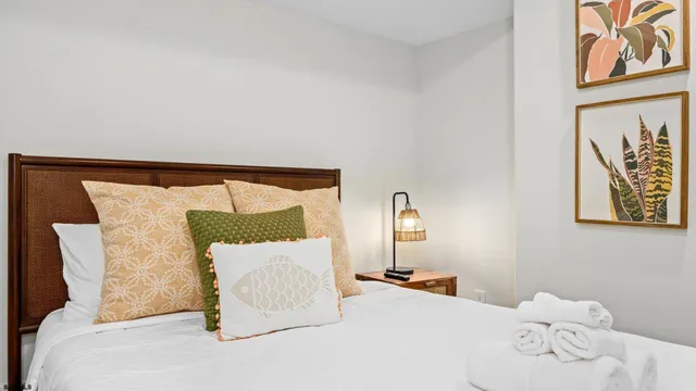 a bedroom with a bed and lamp